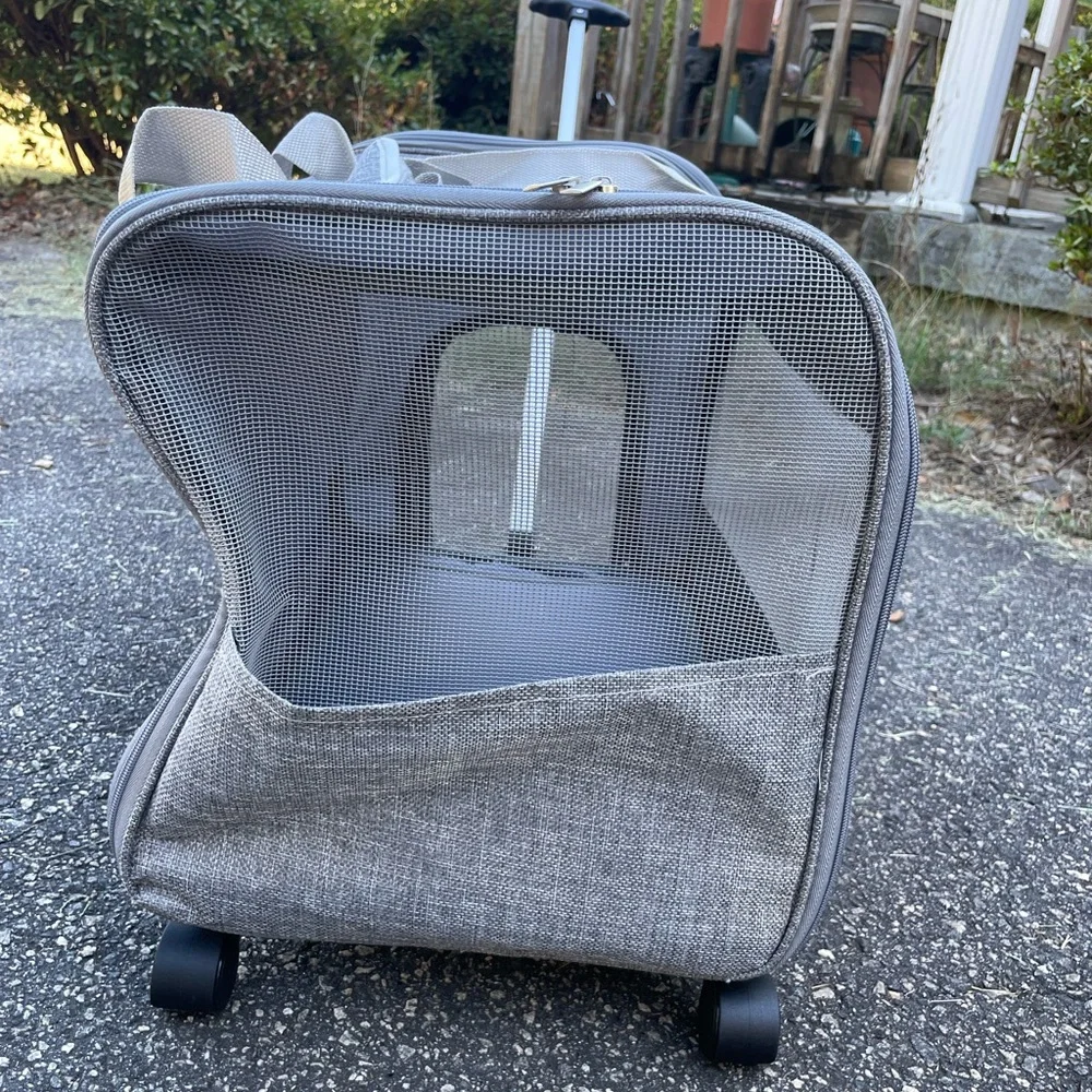 A pet travel carrier and roller. 2 doors on each side. Detachable roller base.